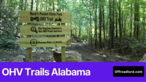Riders at an OHV trailhead in Alabama checking a map board and rules signage before riding, showing OHV trails Alabama planning.
